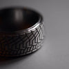 Gold tire-tread ring, racing-inspired men’s wedding band in black grunge, white or yellow gold, low-profile tread pattern, motorsport statement jewelry