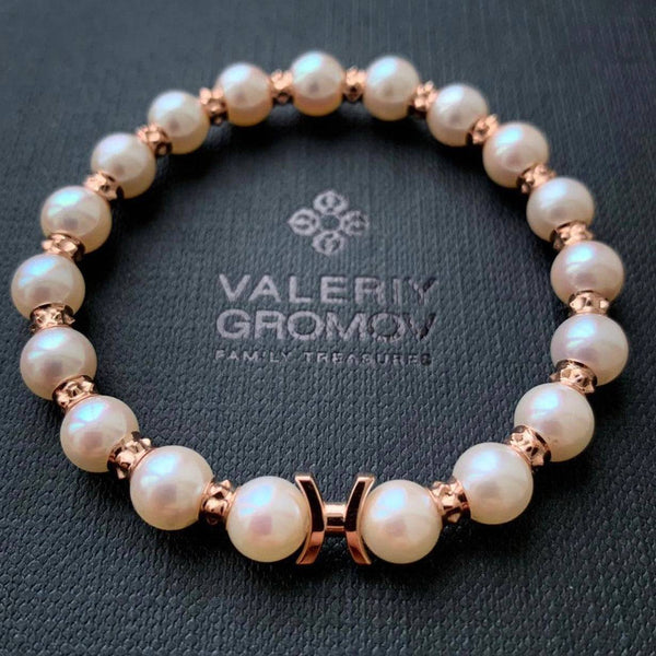 Pearl bracelet with rose gold Gemini Zodiac Sign accents on a Valery Gromov branded background